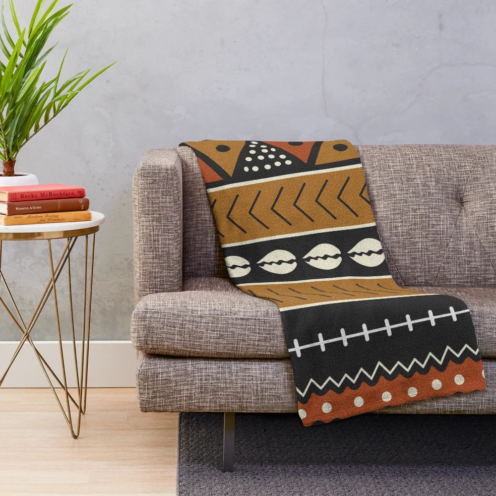 Soft plush mudcloth patterned blanket with geometric shapes and shell accents