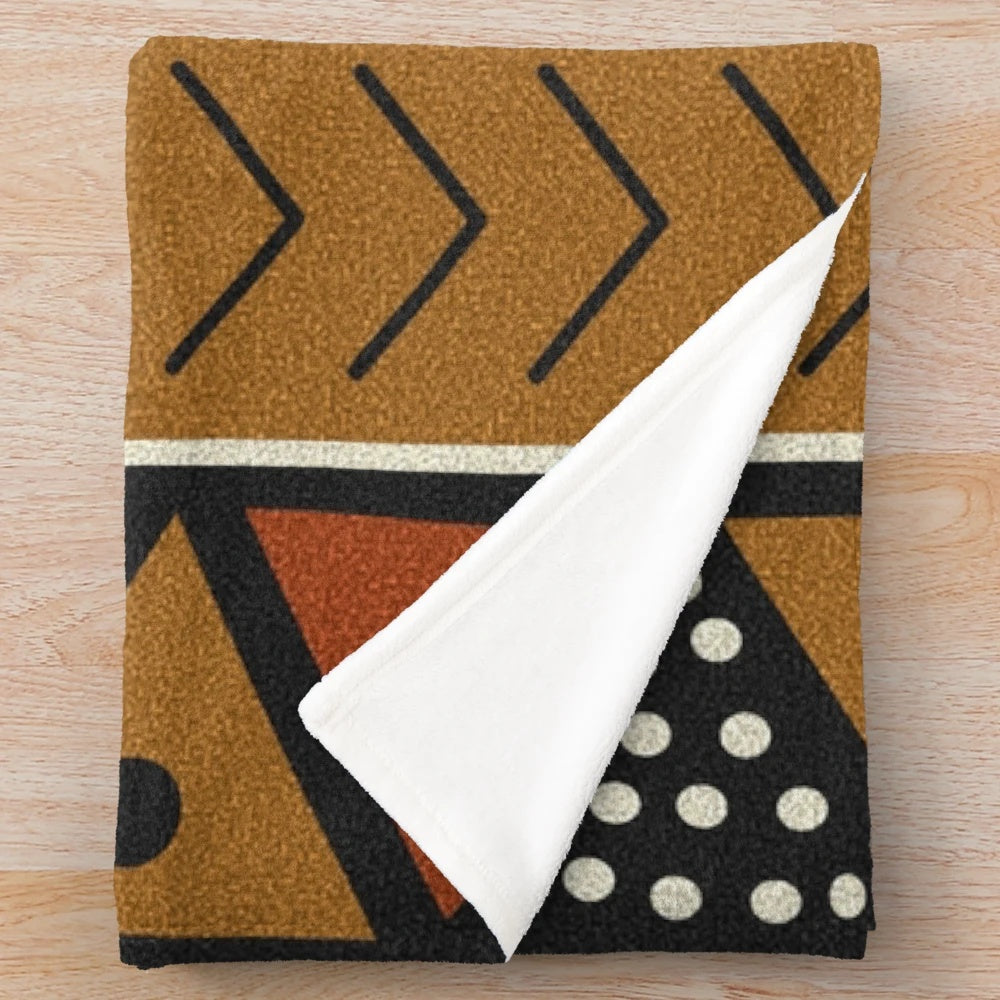 Soft plush mudcloth patterned blanket with geometric shapes and shell accents