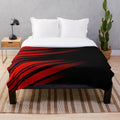 Red and black striped plush blanket with a minimalist geometric pattern