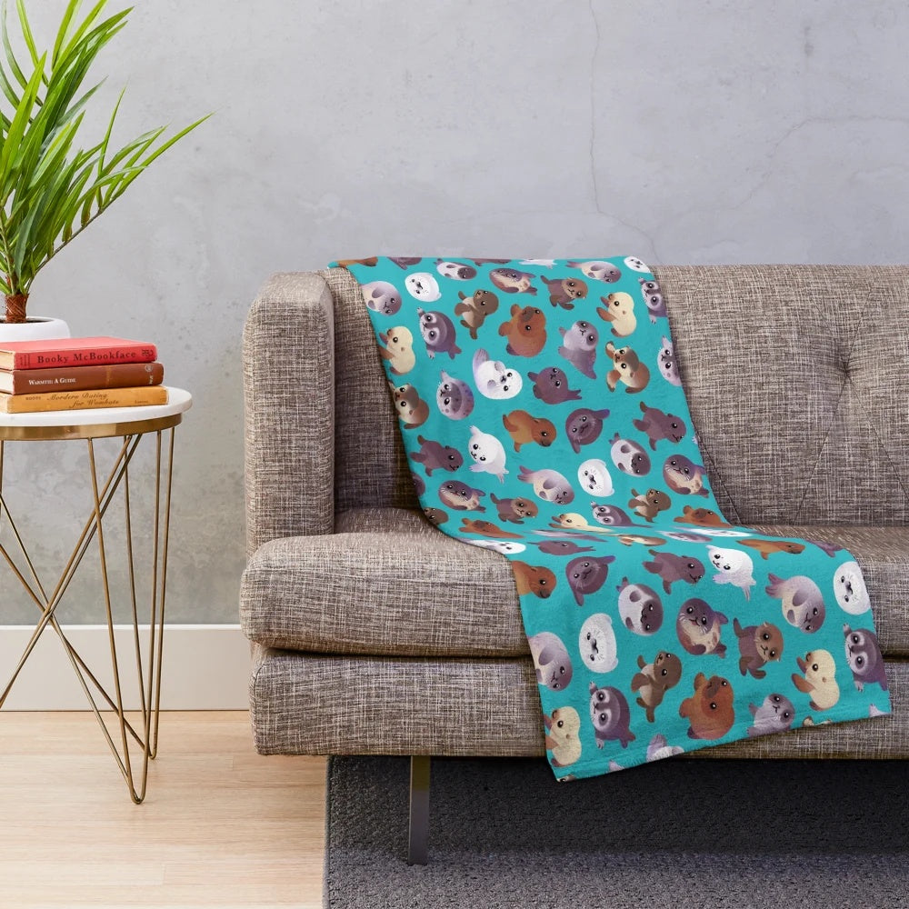 Soft and cuddly plush blanket featuring a cute seal pup design