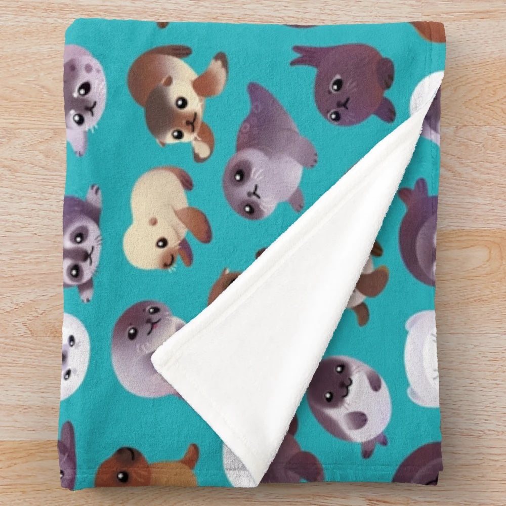 Soft and cuddly plush blanket featuring a cute seal pup design