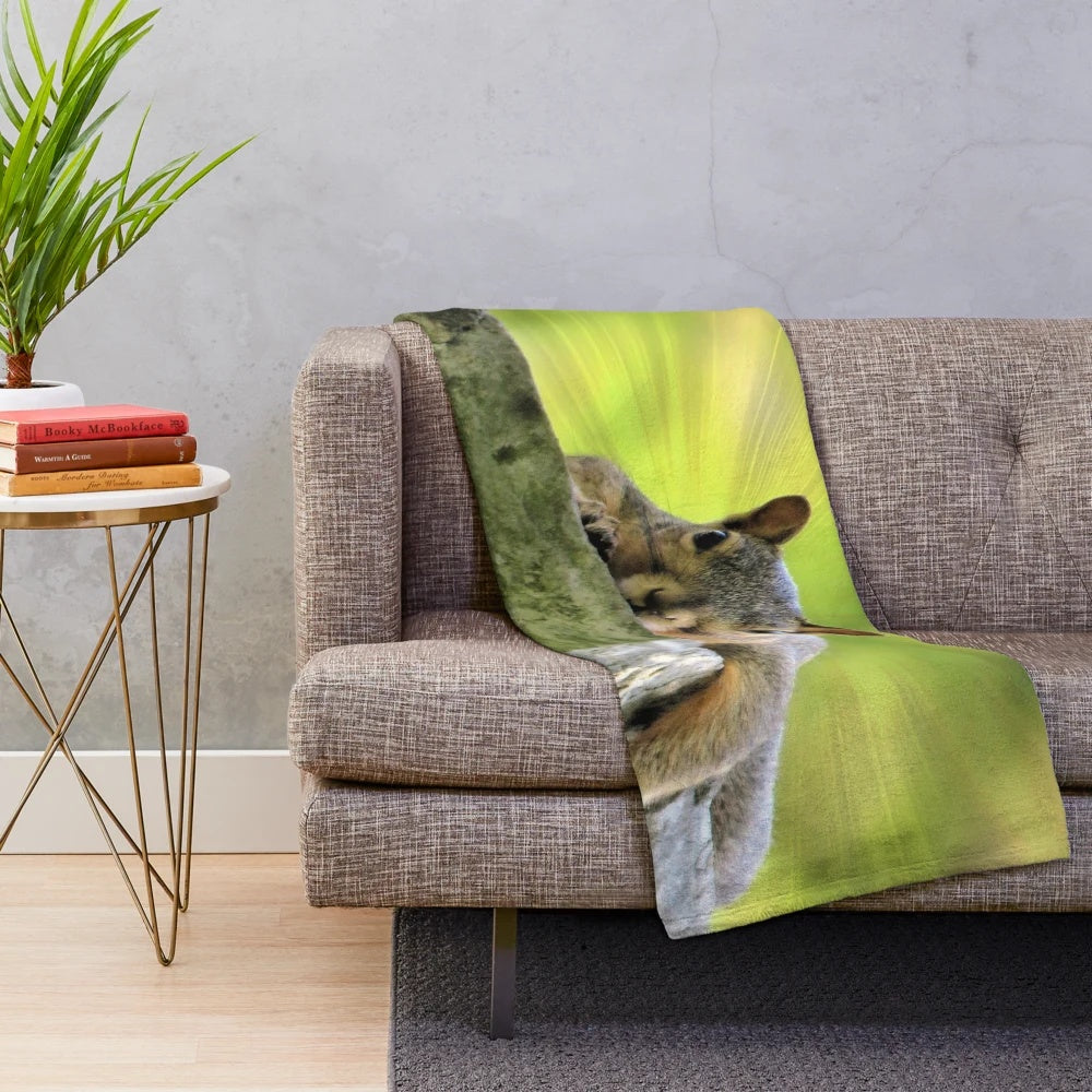 Plush squirrel-shaped blanket in a relaxed, lounging pose