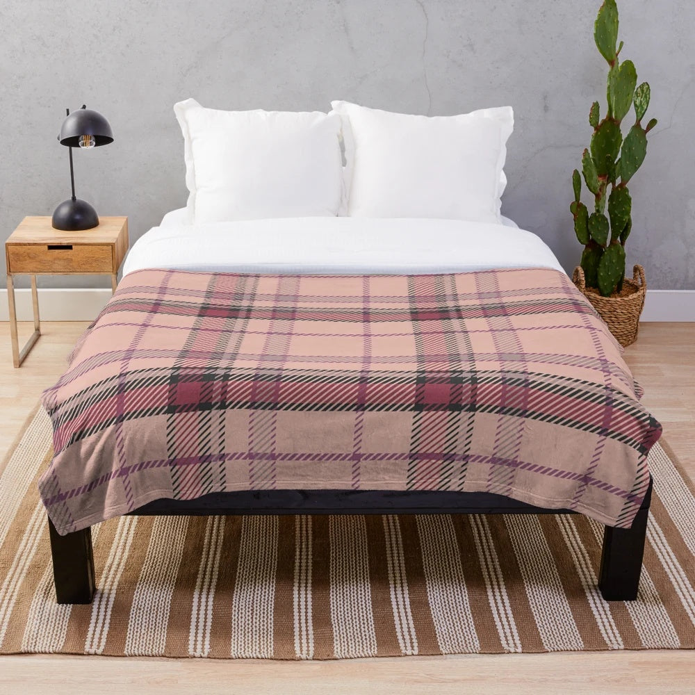 Plush tartan blanket featuring a classic Scottish pattern in pink and brown tones