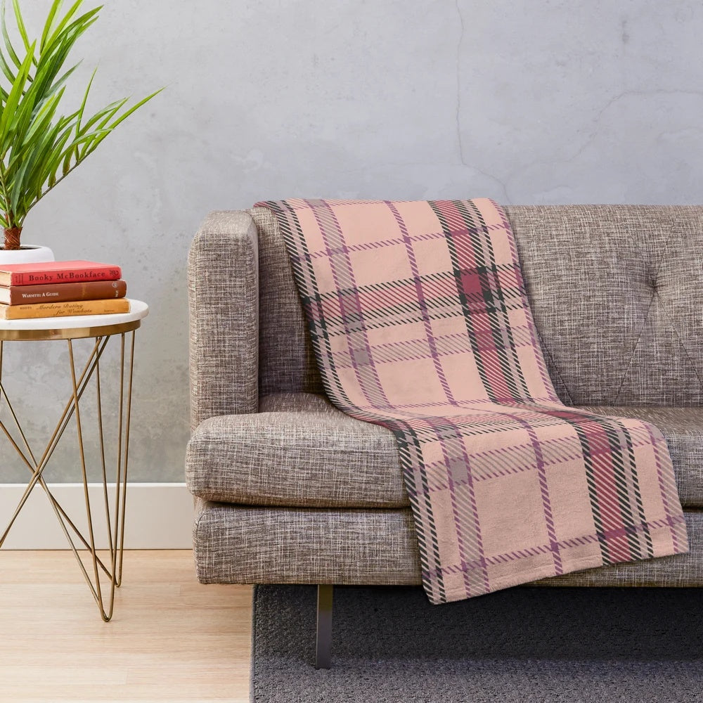Plush tartan blanket featuring a classic Scottish pattern in pink and brown tones