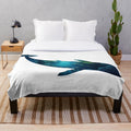 Plush whale-shaped blanket with underwater ocean scene