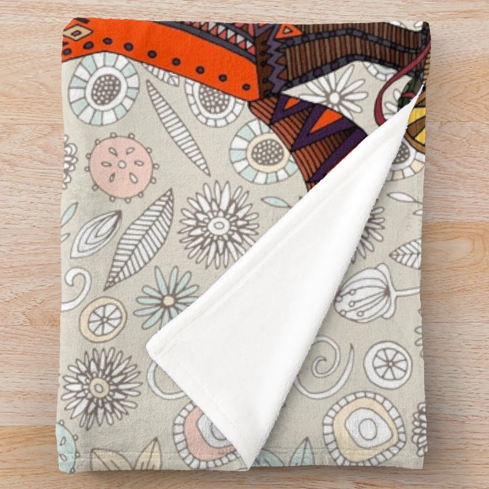 Soft and cozy plush blanket with a woodland animal and bird floral pattern
