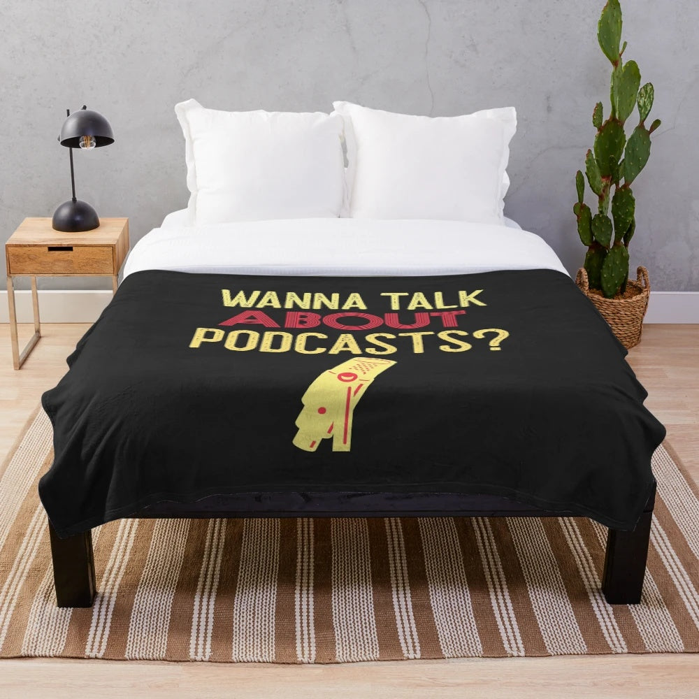A soft and cozy plush blanket featuring a handlettered "Wanna Talk About Podcasts" design, perfect for true crime podcast fans.