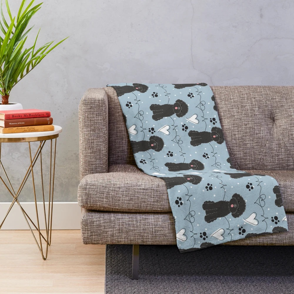 A soft and cuddly plush blanket featuring a poodle design, perfect for poodle lovers.