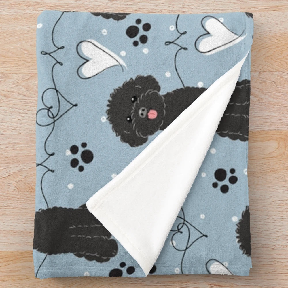 A soft and cuddly plush blanket featuring a poodle design, perfect for poodle lovers.