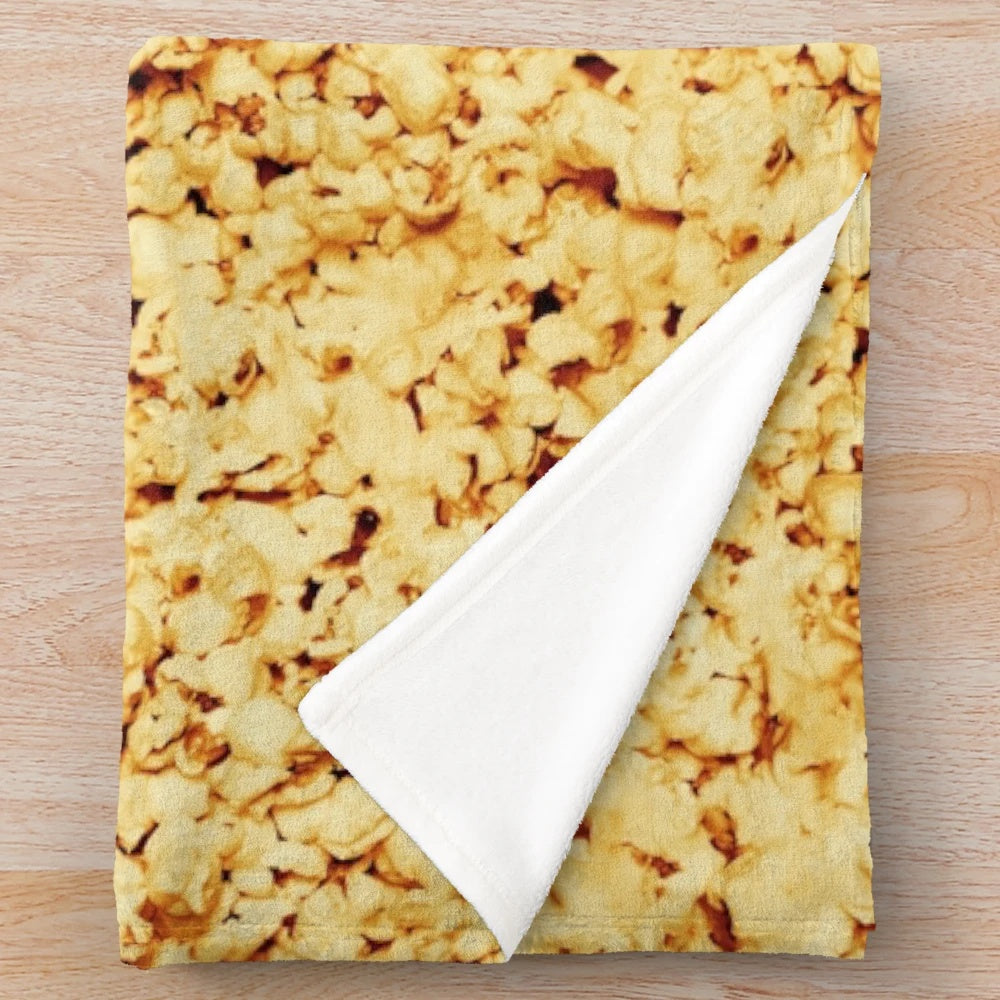 Plush blanket with a fun popcorn pattern, perfect for movie nights and cozy date nights.