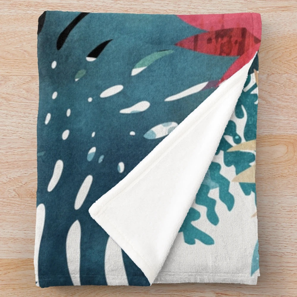 Popoki plush blanket featuring tropical Hawaii inspired floral pattern with anthurium and plumeria flowers