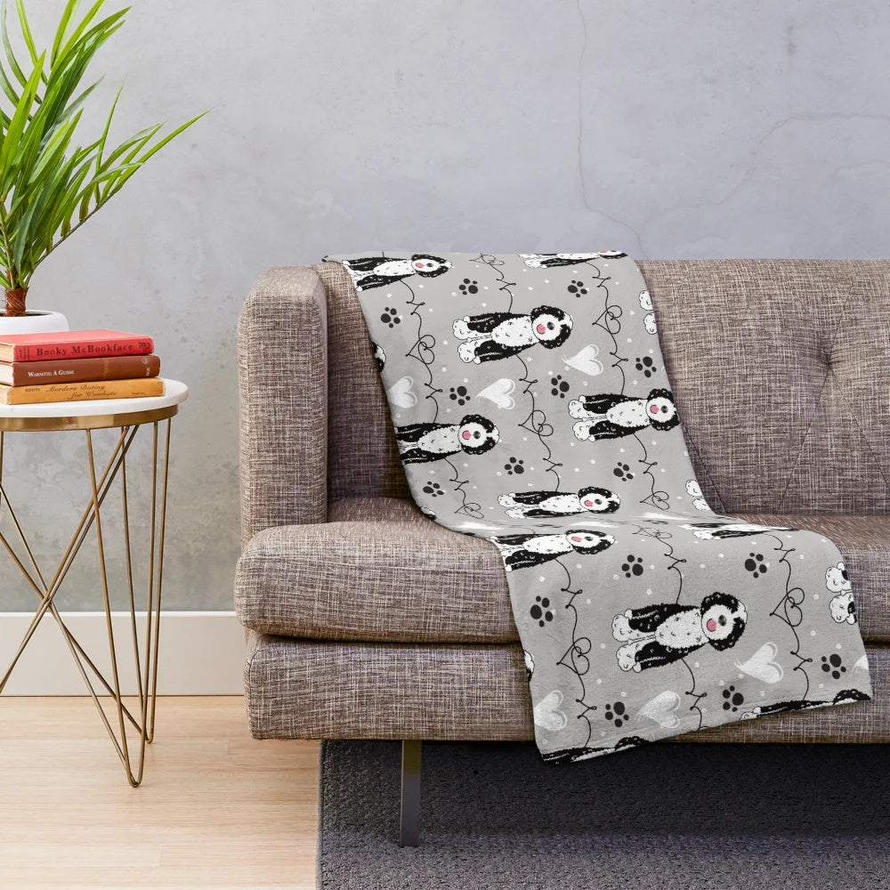 Soft and cuddly Portuguese Water Dog plush blanket with a black and white pattern