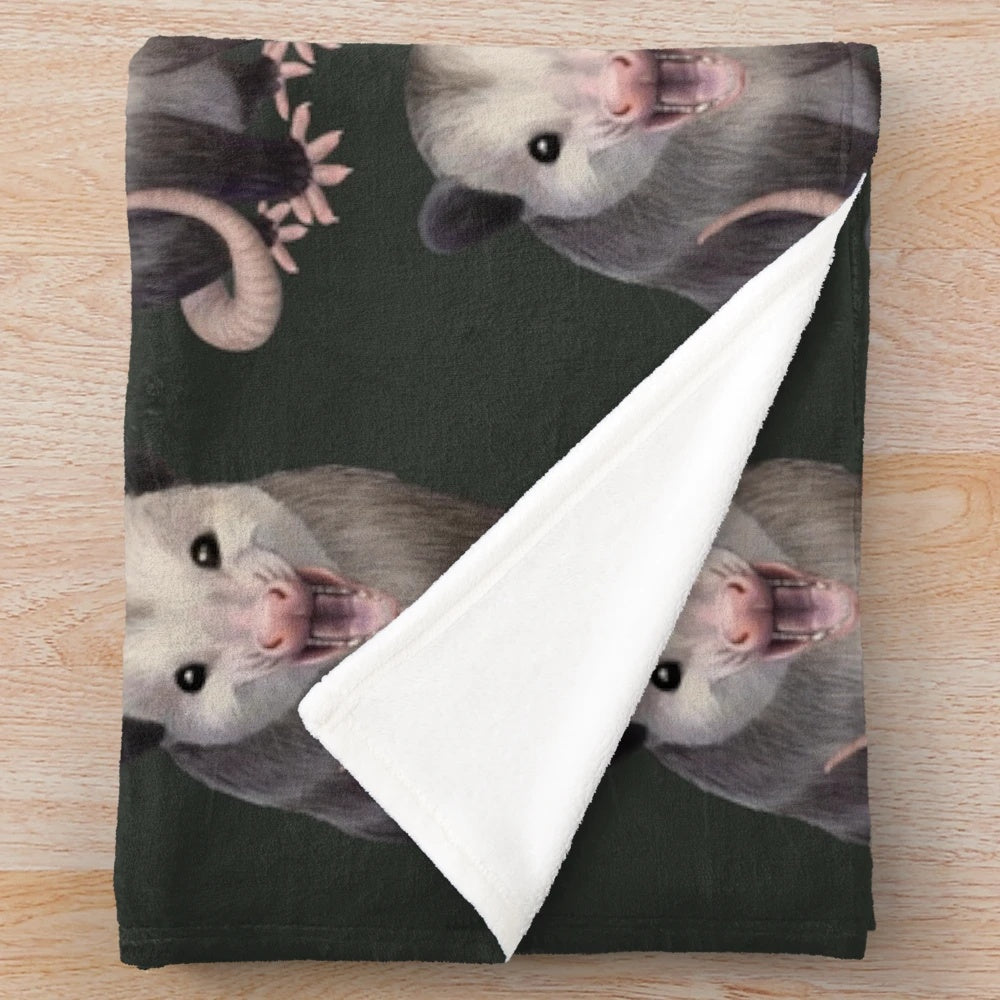 Possum plush blanket with a happy, yawning possum design