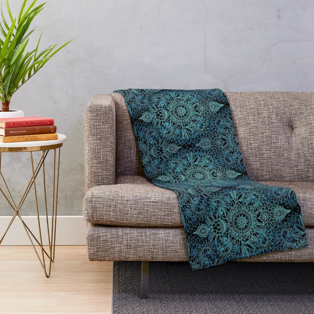Plush blanket featuring a detailed protea doodle pattern in teal, blue, and black