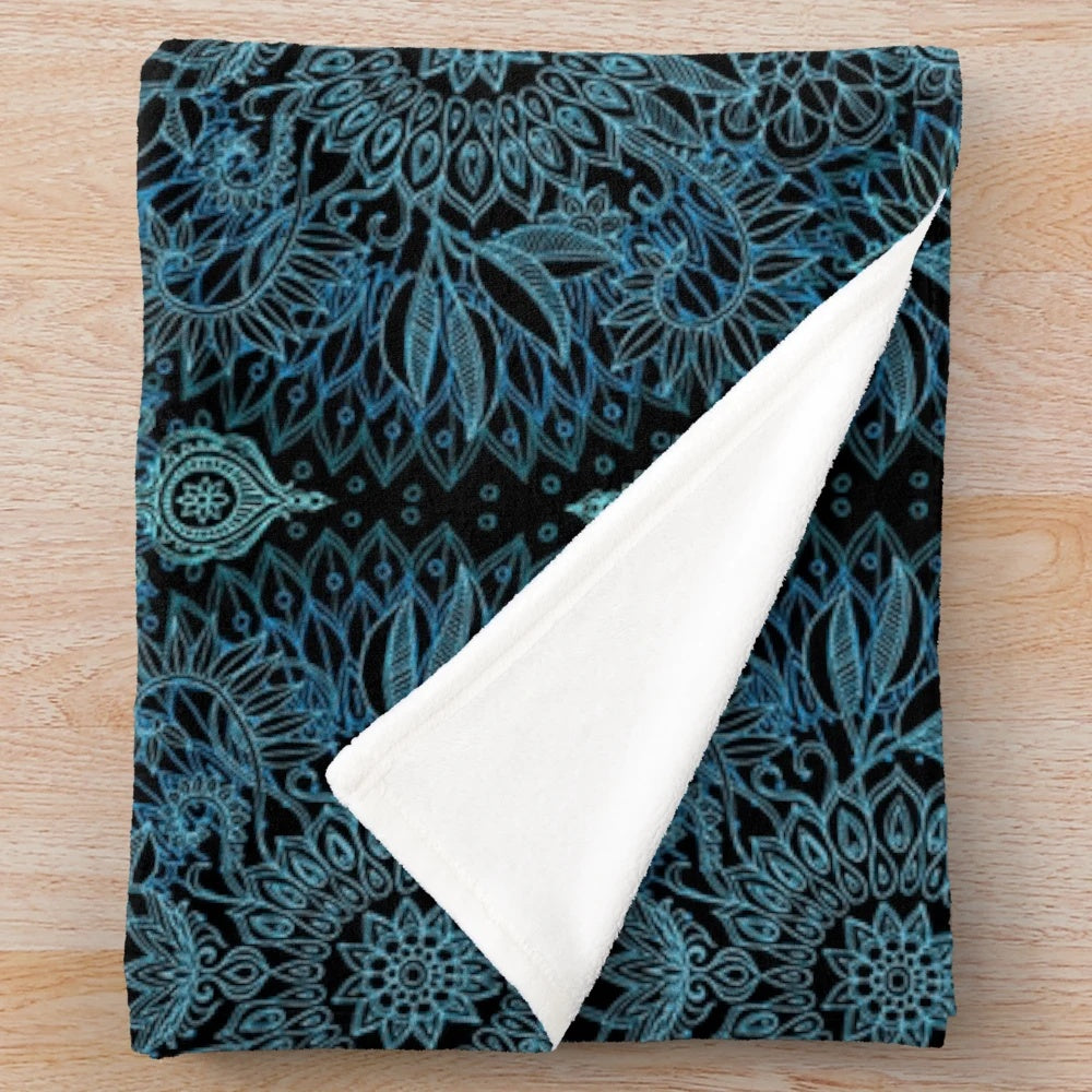 Plush blanket featuring a detailed protea doodle pattern in teal, blue, and black