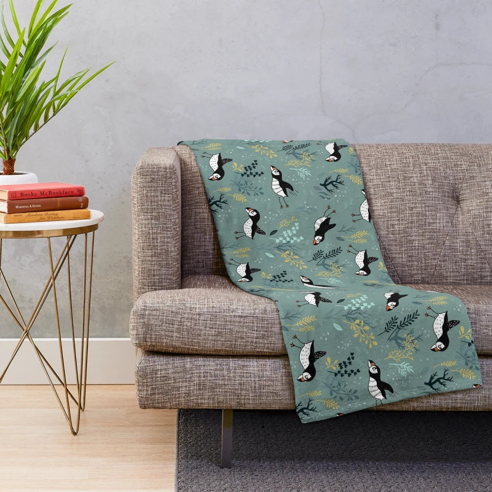 Puffin plush blanket featuring an underwater puffin design