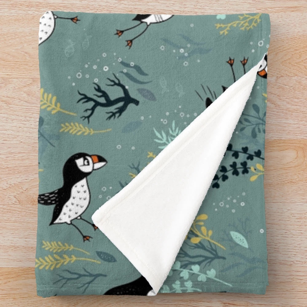 Puffin plush blanket featuring an underwater puffin design