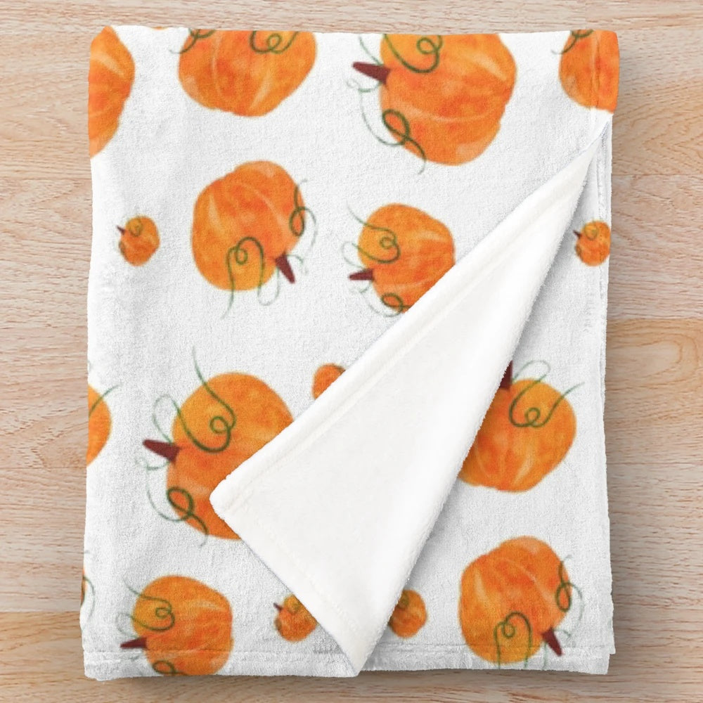 Watercolor pumpkin design on a plush, soft blanket