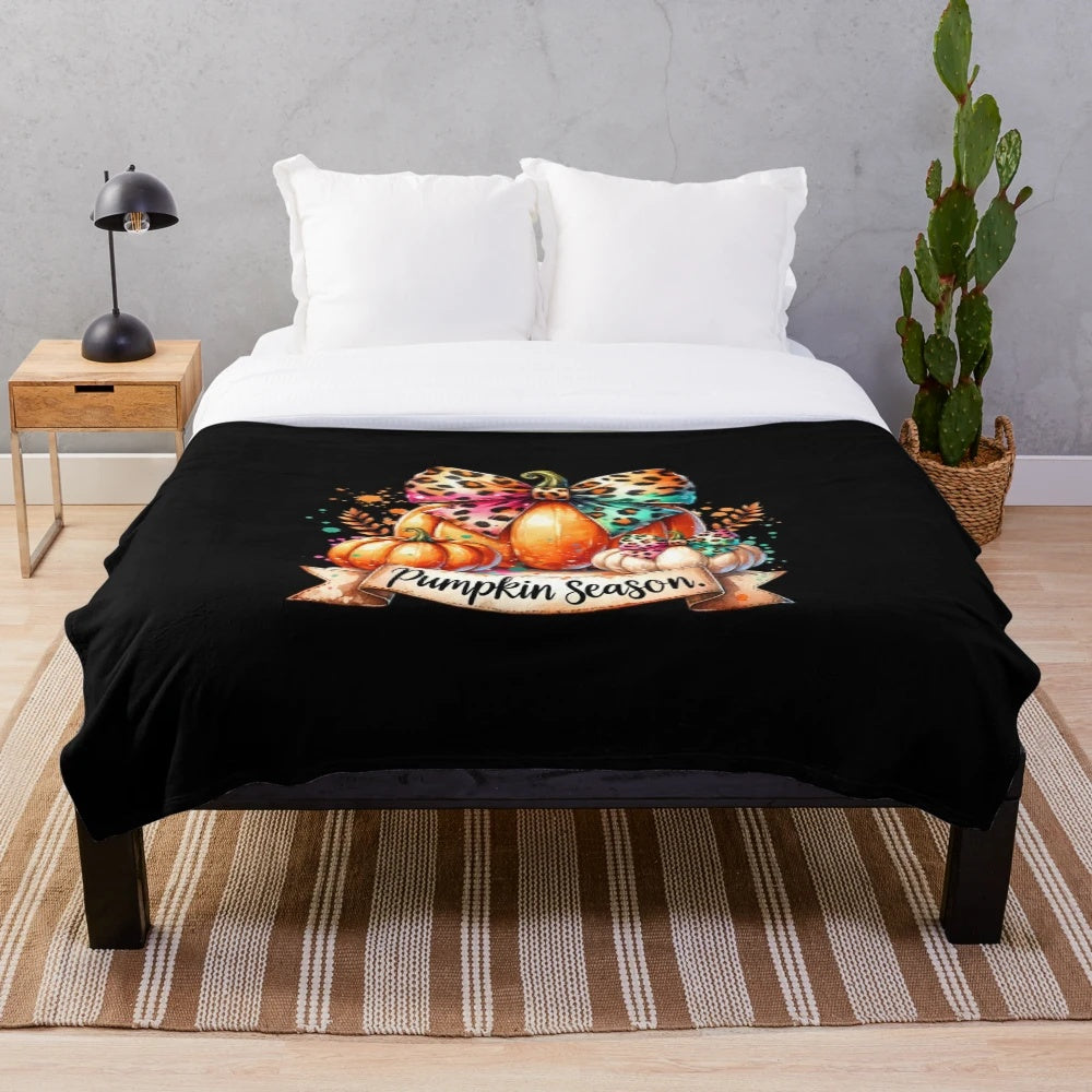 Whimsical pumpkin season artwork featured on a plush, cozy blanket