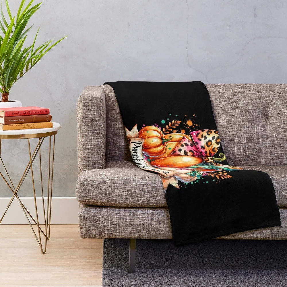 Whimsical pumpkin season artwork featured on a plush, cozy blanket