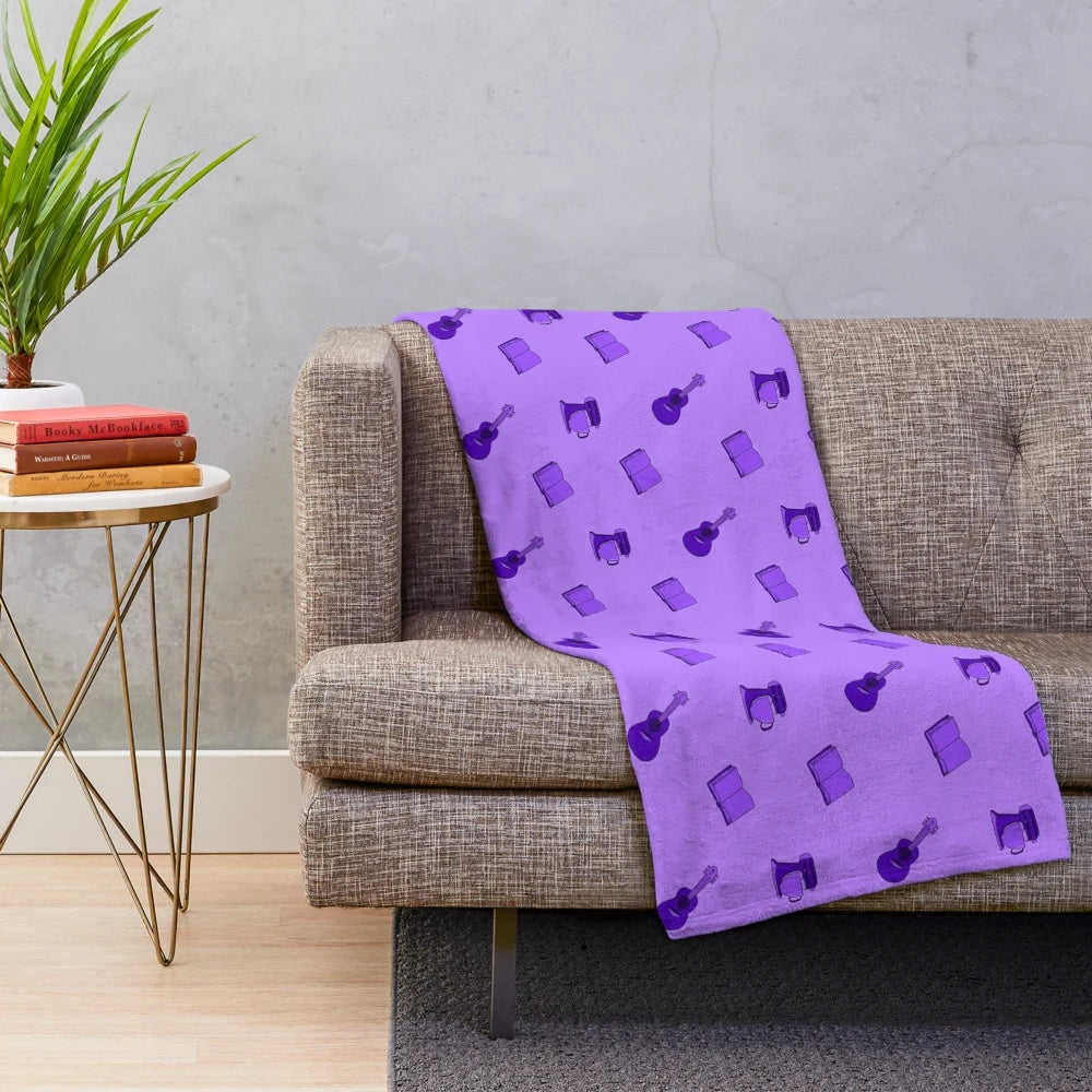 Purple plush blanket with various hobby-related patterns