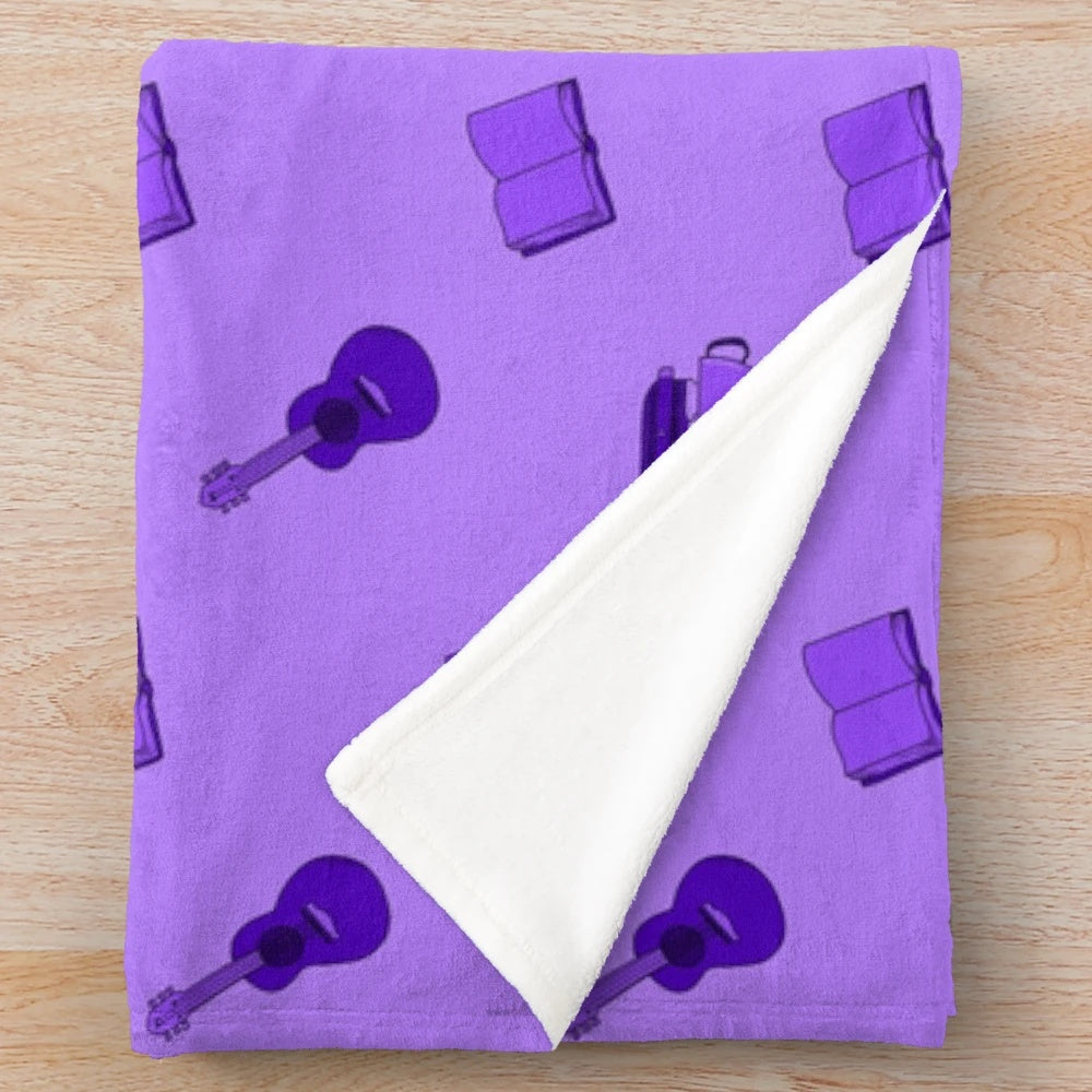 Purple plush blanket with various hobby-related patterns