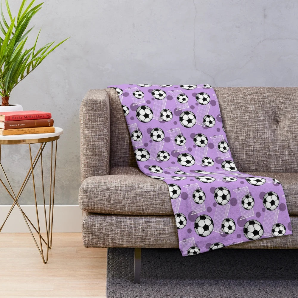 Purple soccer-themed plush blanket with soccer ball and goal pattern