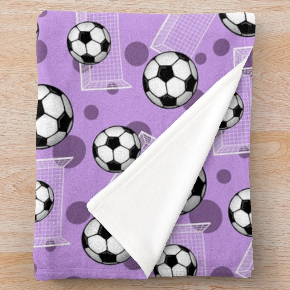 Purple soccer-themed plush blanket with soccer ball and goal pattern