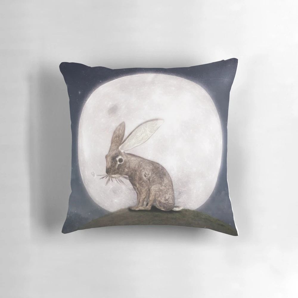 A soft, plush rabbit pillow with a design of a crescent moon and stars against a dark night sky.