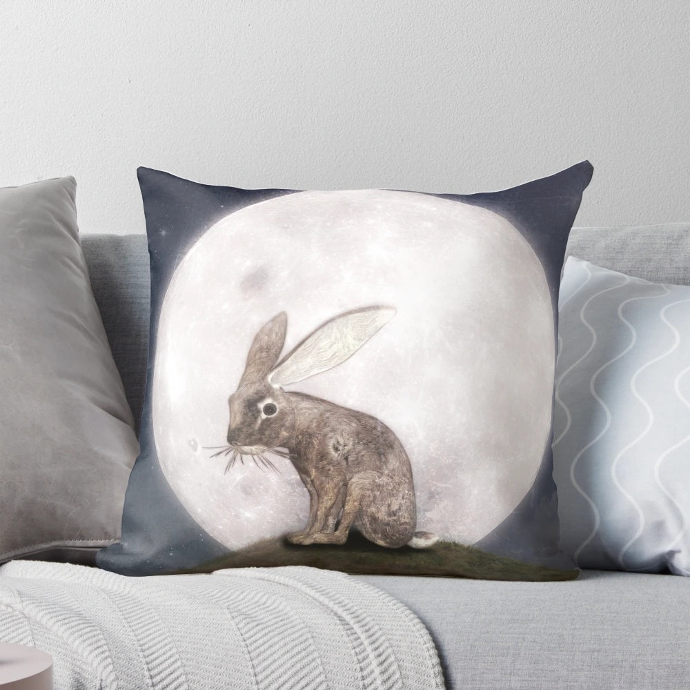 A soft, plush rabbit pillow with a design of a crescent moon and stars against a dark night sky.