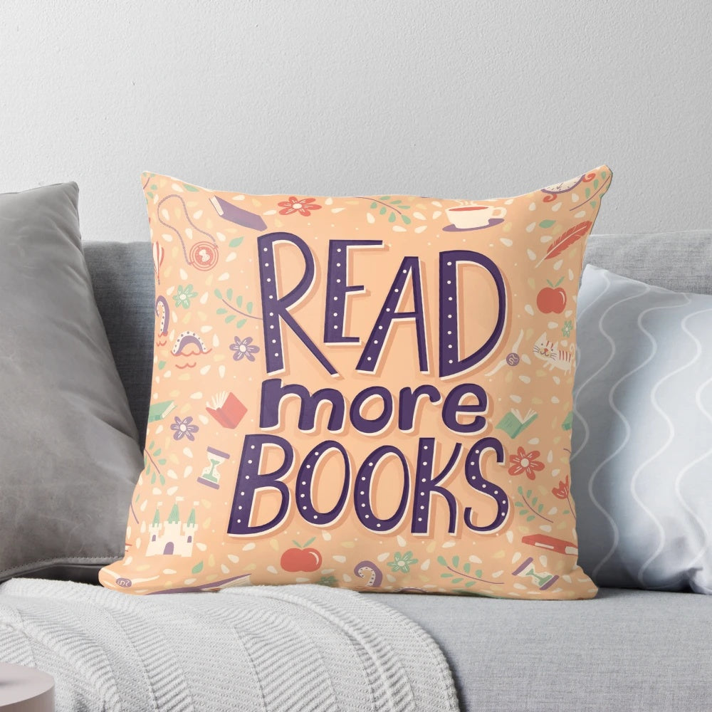 A white pillow with the text "Read More Books" in a stylish font