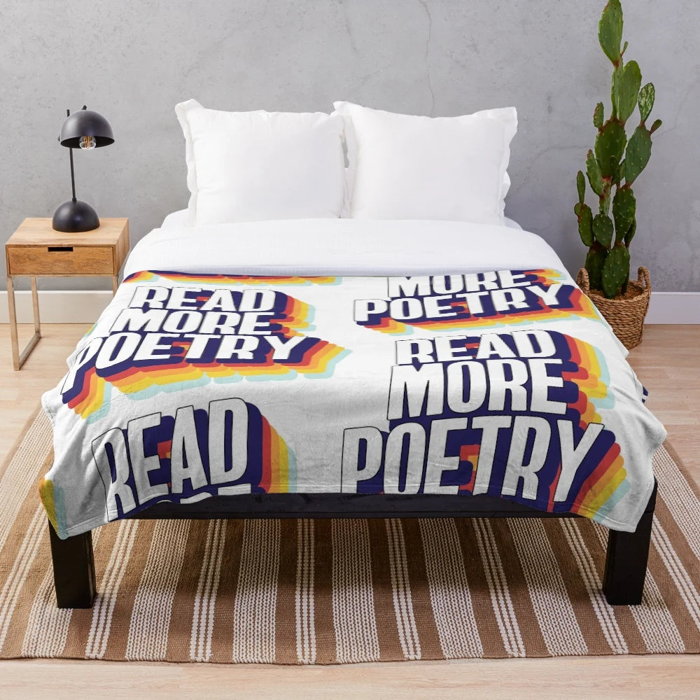 Colorful plush blanket with "Read More Poetry" text