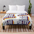 Colorful plush blanket with "Read More Poetry" text