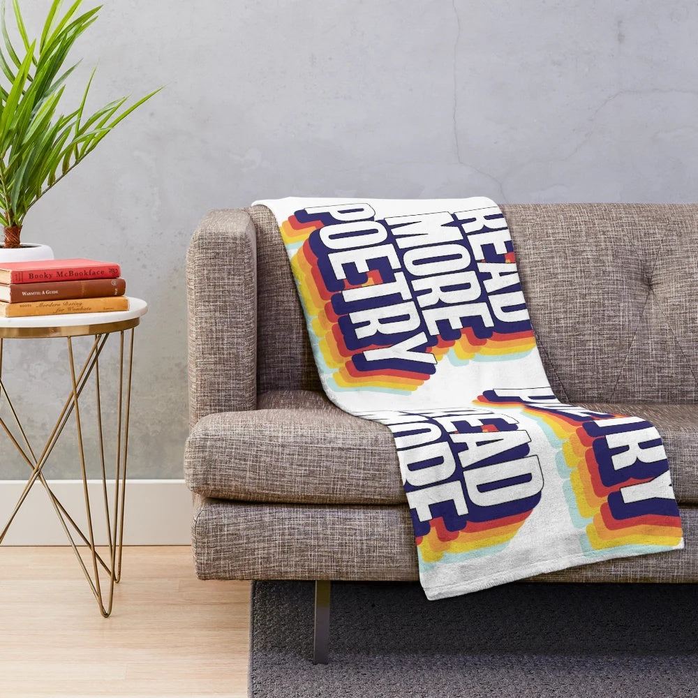 Colorful plush blanket with "Read More Poetry" text