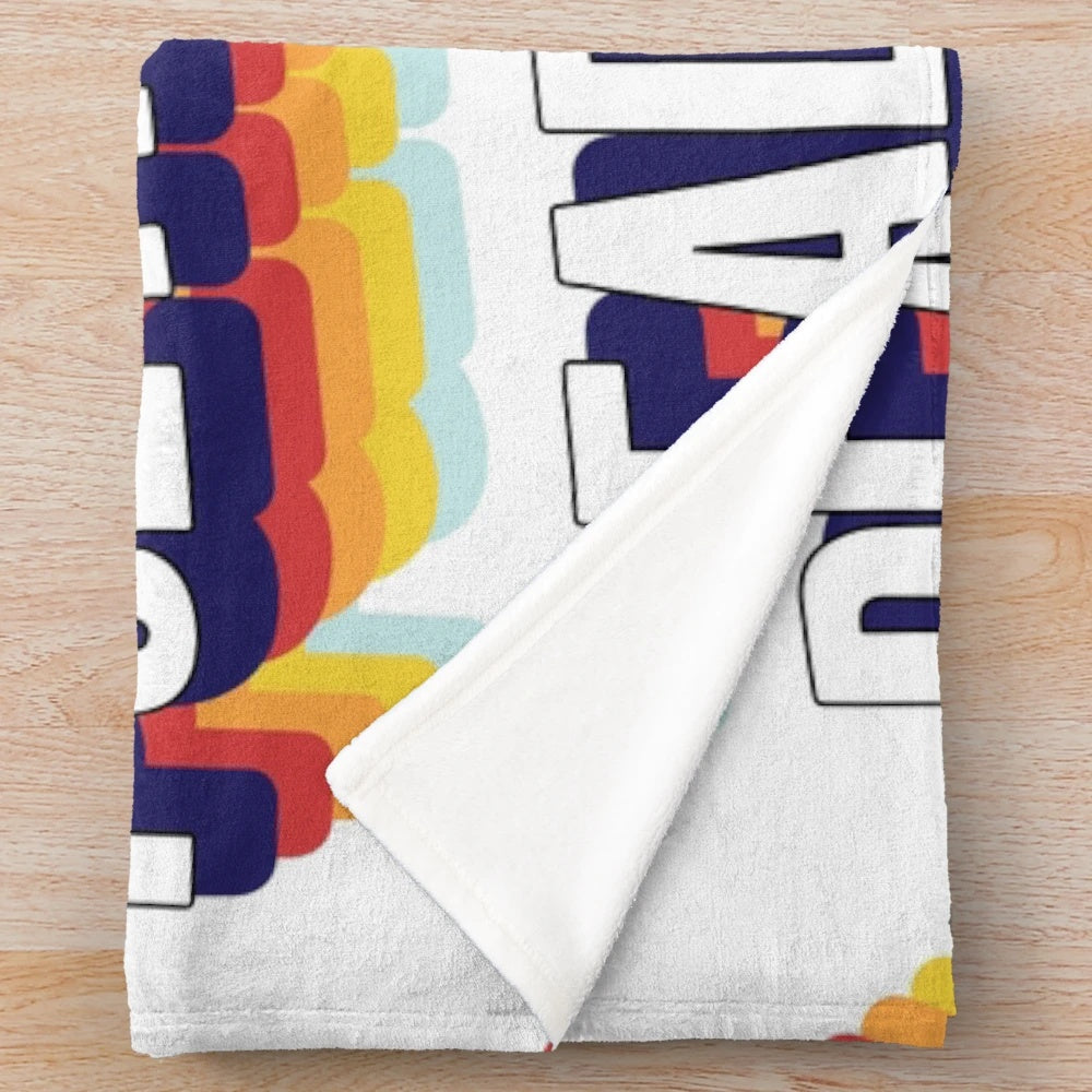 Colorful plush blanket with "Read More Poetry" text
