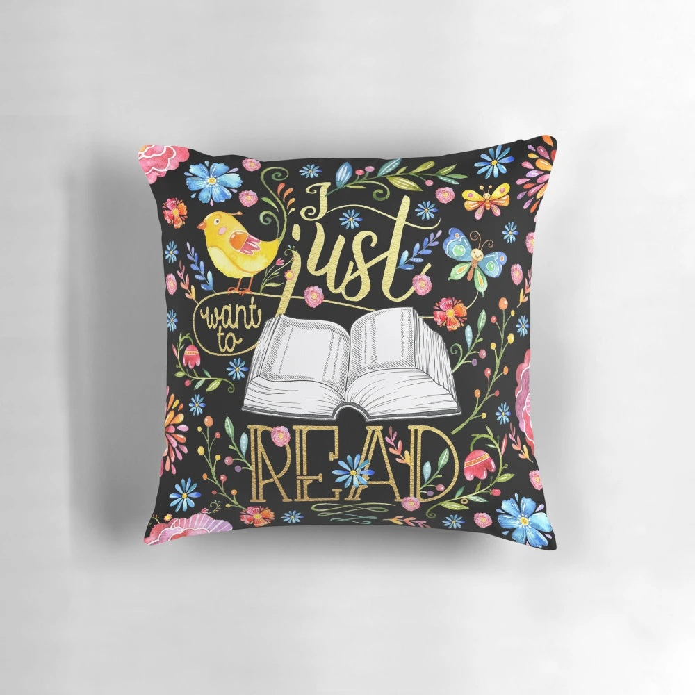A black floral pillow with a whimsical design, perfect for bookworms and readers to enjoy.