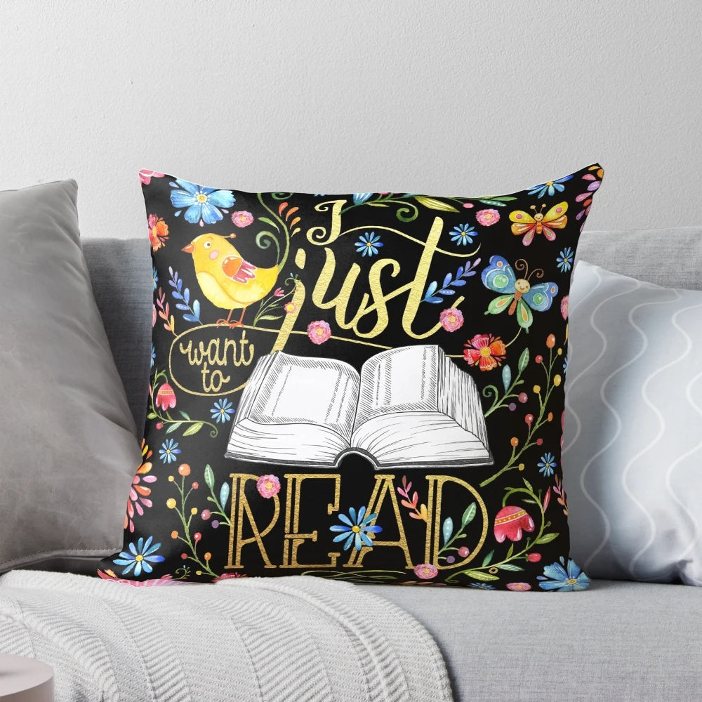 A black floral pillow with a whimsical design, perfect for bookworms and readers to enjoy.