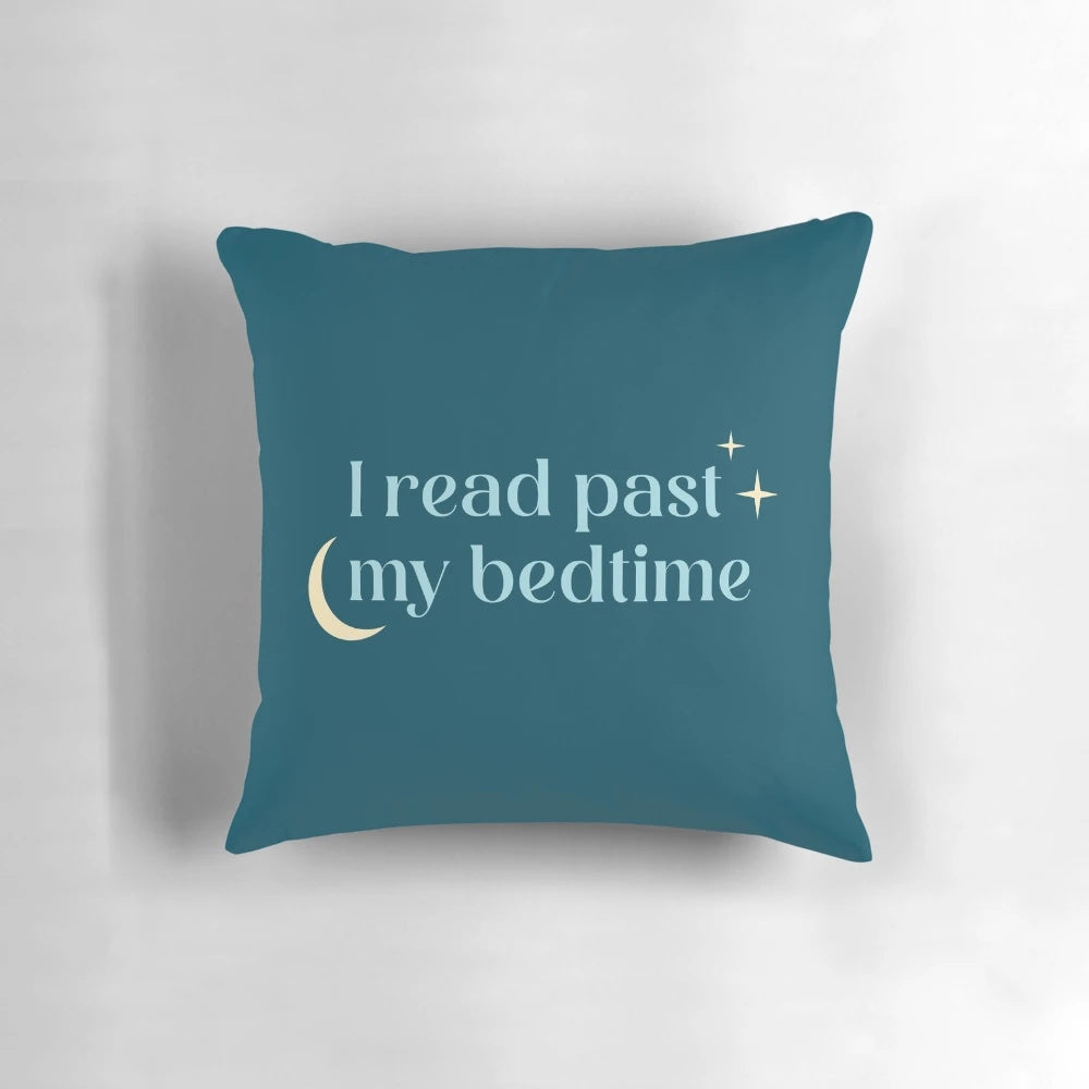 A plush, blue pillow with the text "I Read Past My Bedtime" printed on it.