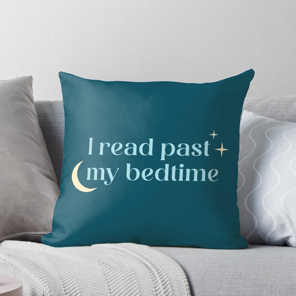 A plush, blue pillow with the text "I Read Past My Bedtime" printed on it.