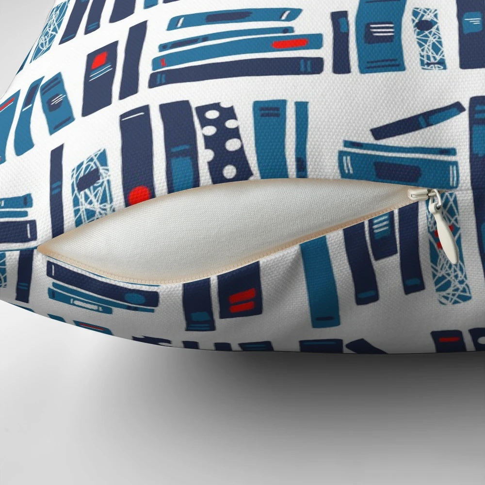 A plush reading pillow with a blue and red book pattern, perfect for cozy reading sessions.