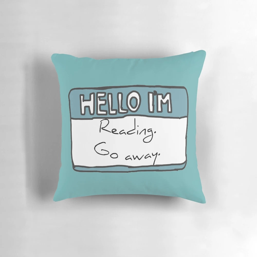A blue pillow with the text "Hello I'm Reading" in a fun, hand-drawn style.