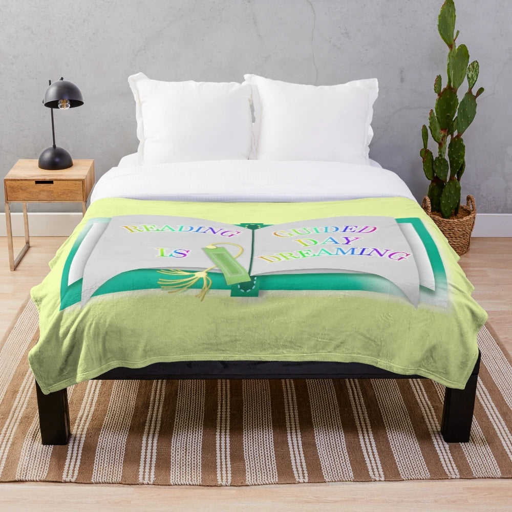 Plush blanket featuring the text "Reading is Guided Daydreaming