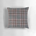 A cozy, red and grey tartan plaid throw pillow with a soft, woollen texture.