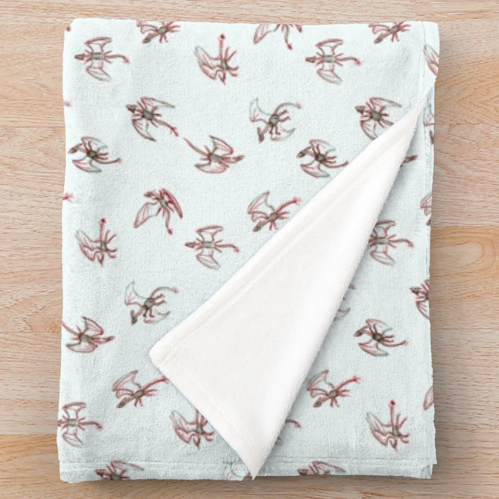 Soft red dragon plush blanket with a pattern of small dragons