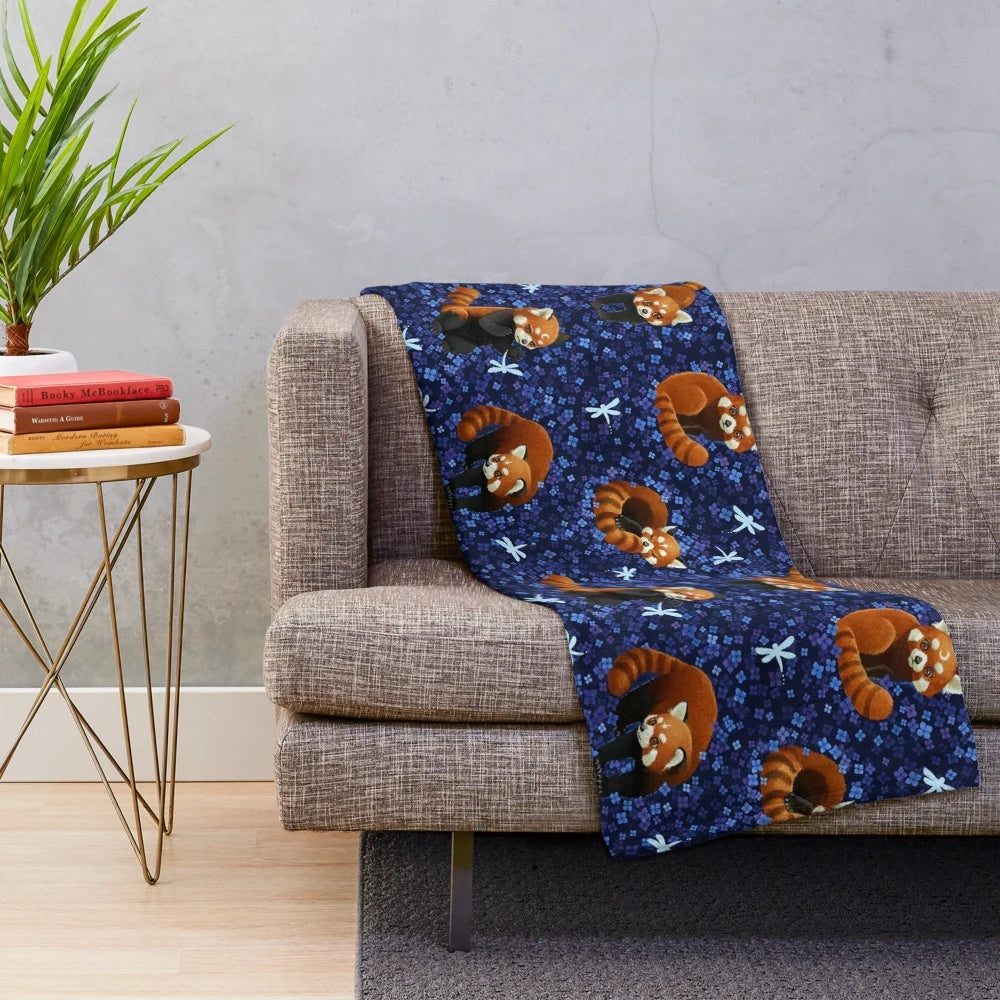 Red panda plush blanket with a colorful floral and nature-inspired pattern