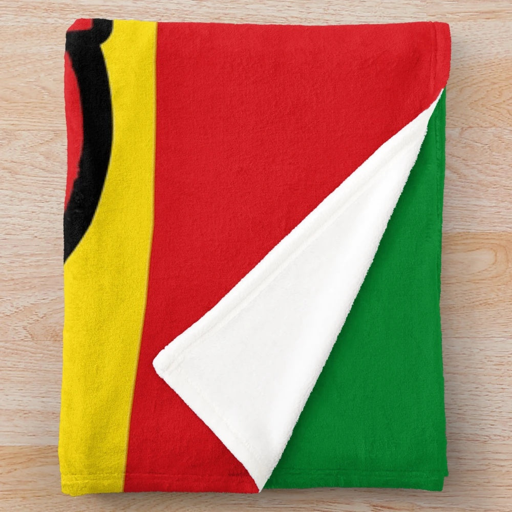 Reggae-inspired plush blanket with peace symbol and rasta colors