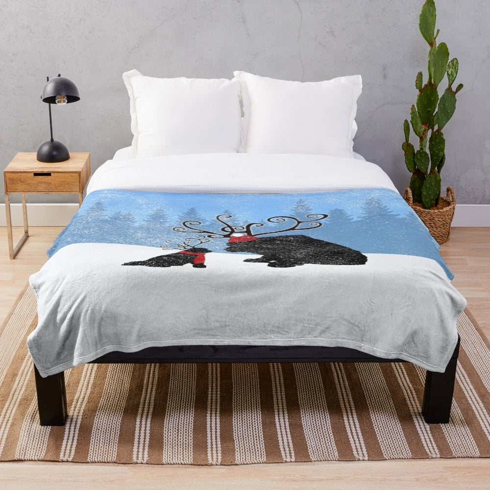 Reindeer-themed plush blanket featuring a Newfoundland dog