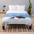 Reindeer-themed plush blanket featuring a Newfoundland dog