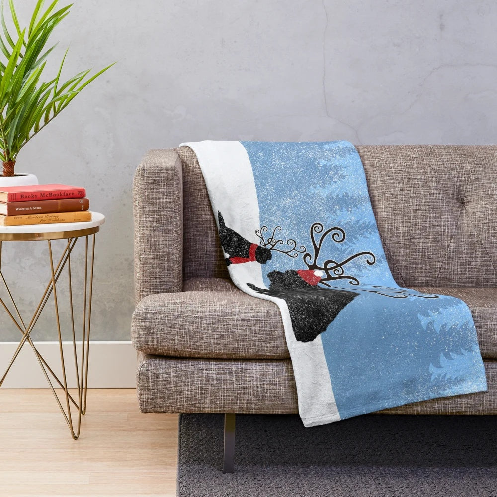 Reindeer-themed plush blanket featuring a Newfoundland dog