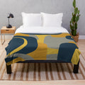 Retro abstract pattern plush blanket in navy, gray, and mustard colors